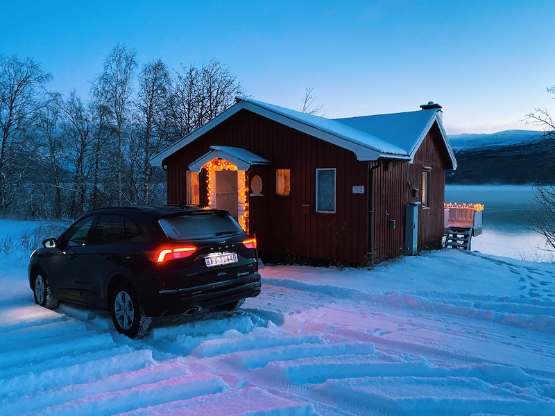 Cabin by a frozen lake near Tromsø